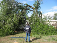 Justin Weaver, NWS Lubbock Meteorologist-In-Charge, surveys damage following severe winds and weak tornado damage in a Childress, TX residential area - located just west of the Childress High School on May 10, 2006. 