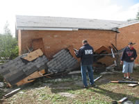 Justin Weaver, NWS Lubbock Meteorologist-In-Charge, surveys damage following severe winds and weak tornado damage in a Childress, TX residential area - located just west of the Childress High School on May 10, 2006. 