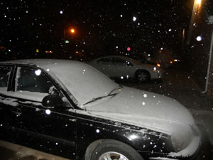 photo of a car covered with snow in central Lubbock