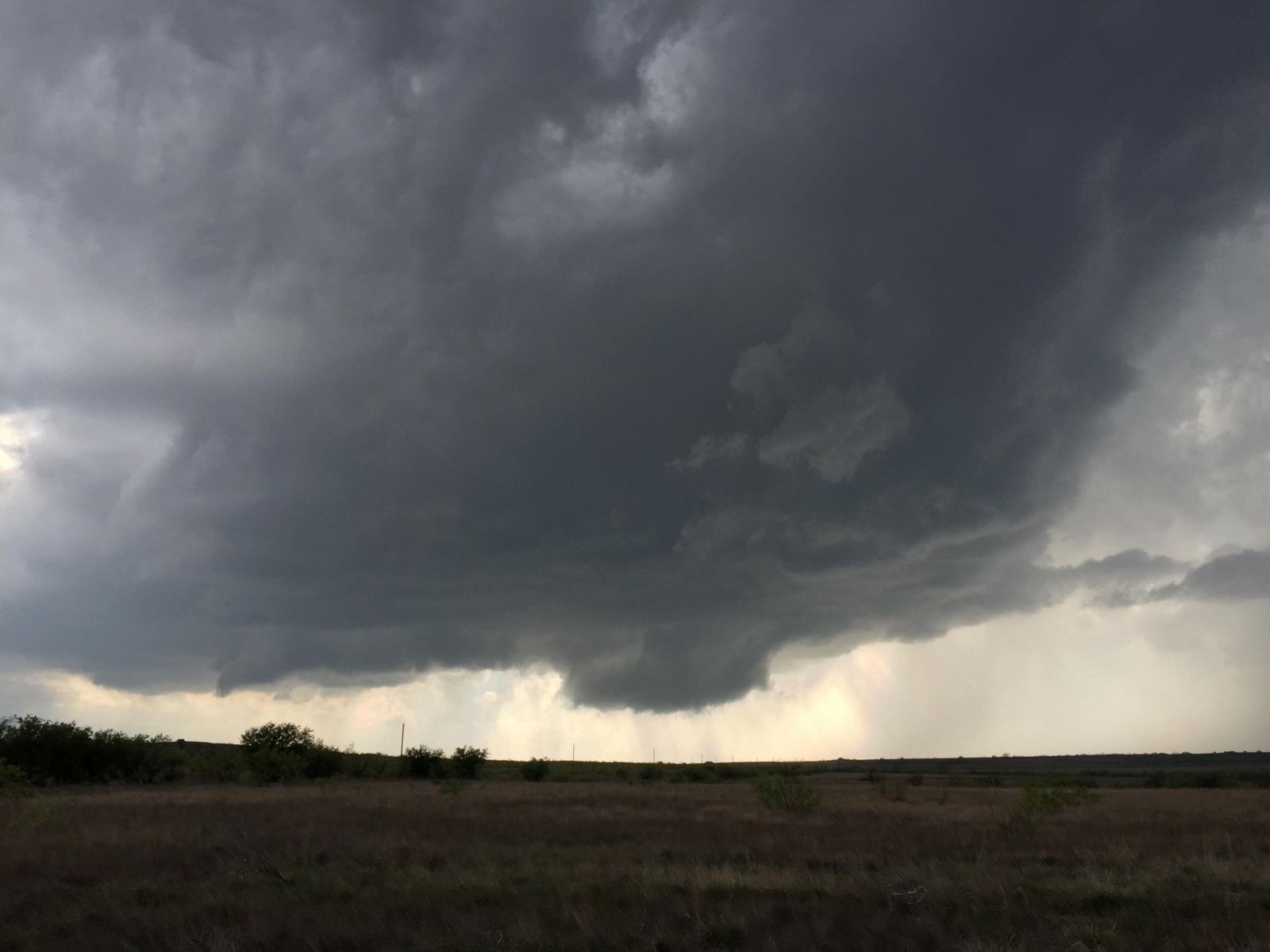 Base and wall cloud of a storm west of Dickens at 5:48 pm on 10 April 2016. The picture is courtesy of Bruce Haynie.