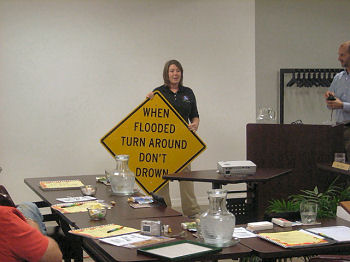 National Weather Service Little Rock Senior Service Hydrologist Tabitha Clarke dedicates high water signs at a Hardy (Sharp County) council meeting on 10/19/2010.