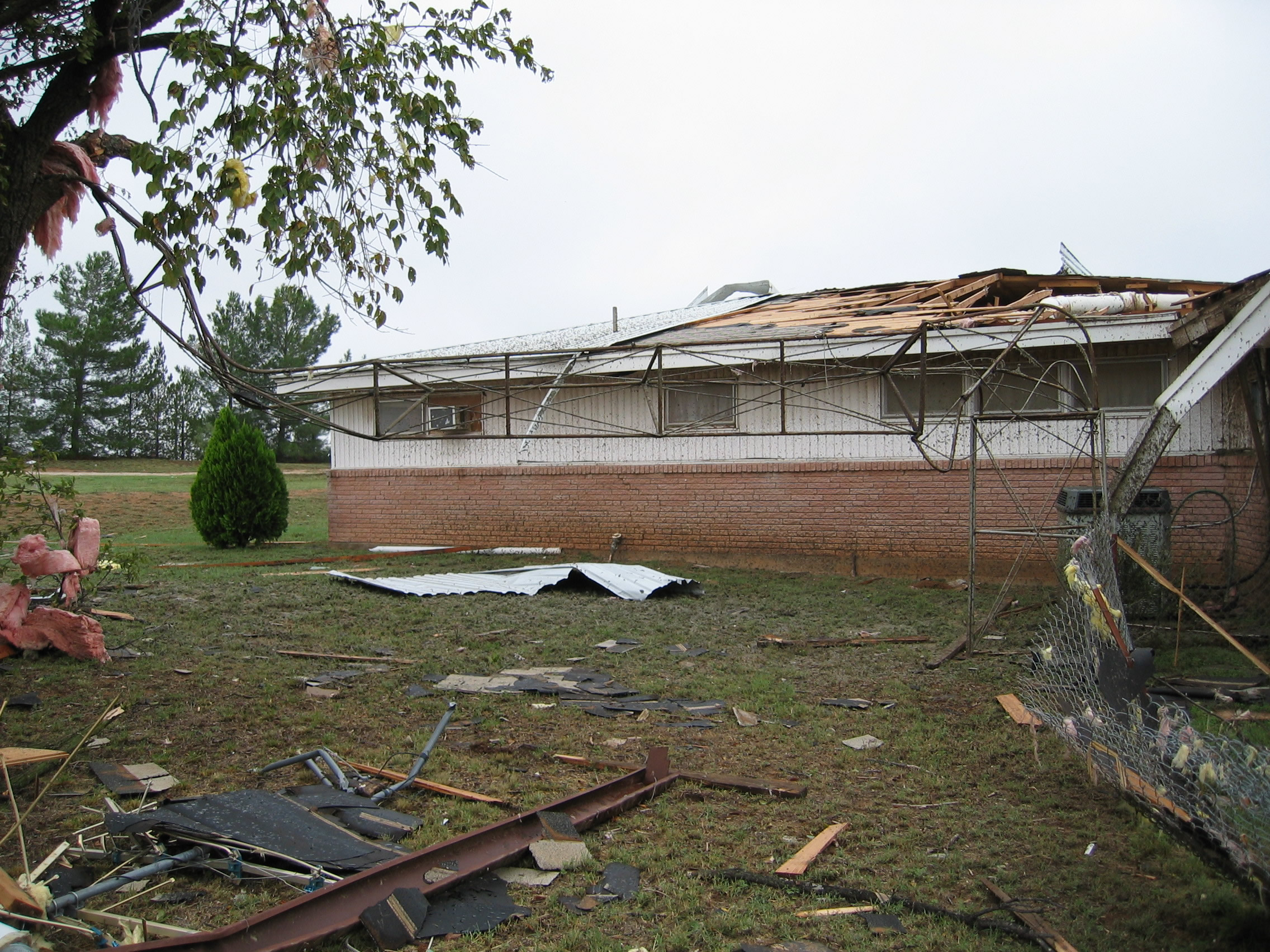 Photo of house with damaged roof, caused by an F1 tornado.