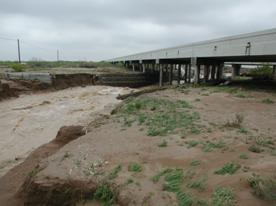 Water flowing under the Interstate 20 bridge near Toyah