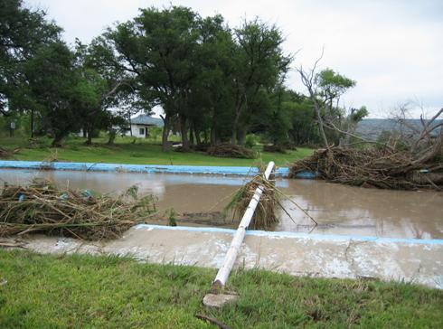 Swimming pool flooded with debris