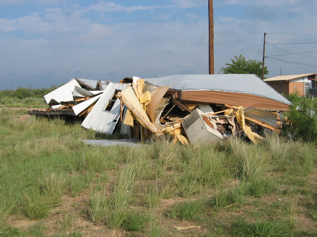 photograph of a destroyed mobile home