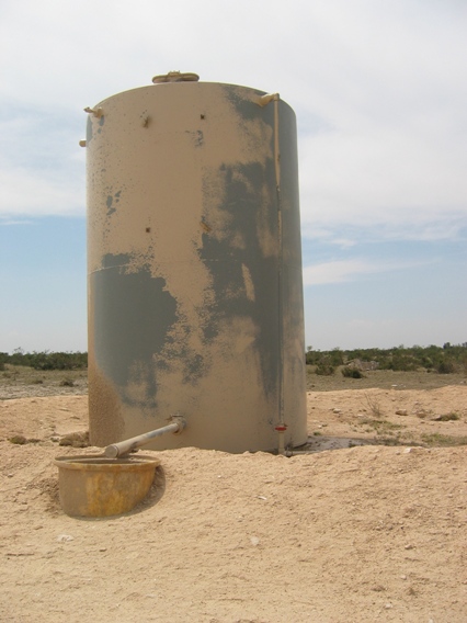 This oil tank was recently painted.  The paint has been removed in many areas. 
