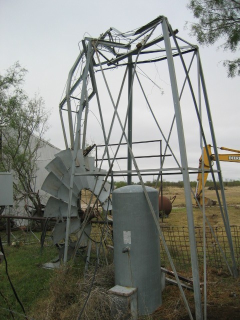 Photo of a bent wind mill near a residence along State Highway 137.