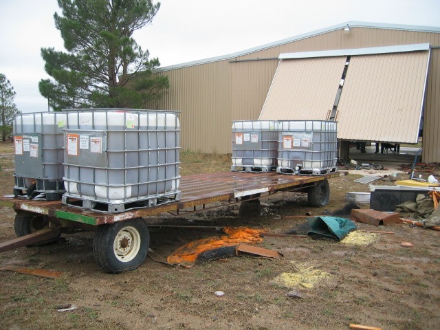 Photo of a 4 ton trailer pushed out of a large metal barn.