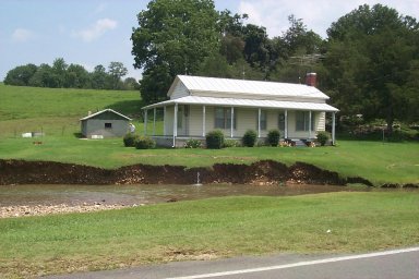 Eroded bank along Horse Creek alongside a house