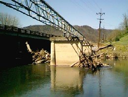 Debris from a recent flood piled up against the old bridge support