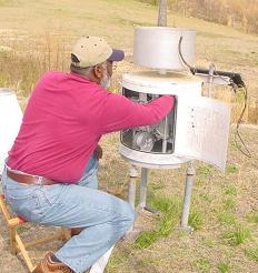 Robert Ussery (retired) services a rain gage - click to enlarge