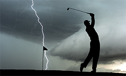 lightning behind a golfer