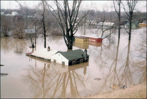 Houses almost completely under water. Credit: Lansing State Journal file photo