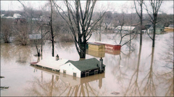 Houses almost completely under water. Credit: Lansing State Journal file photo