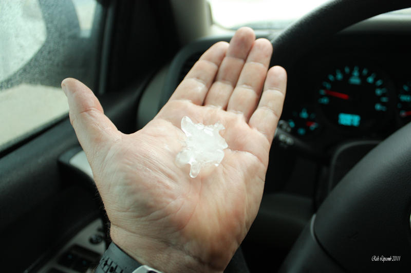 A spotter hold hailstones in his hands that fell from a hailstorm on March 26, 2011 near Colquitt, GA.