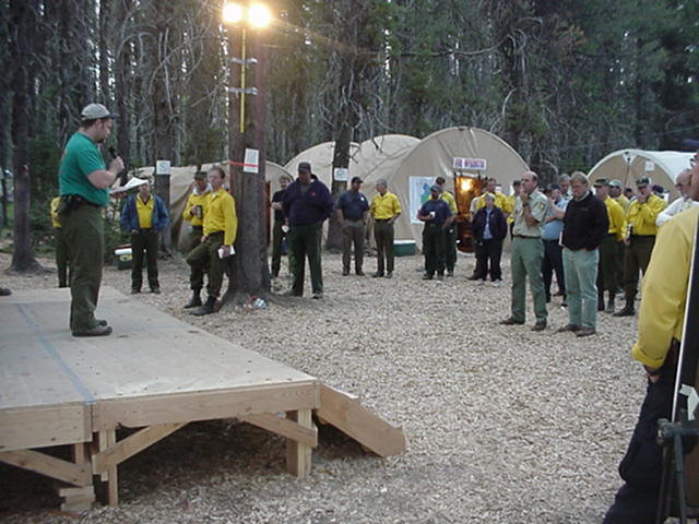A photo of a weather briefing at fire camp.