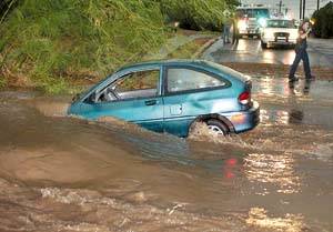Picture of a car caught in a low water crossing due to flash flooding from a summer thunderstorm.