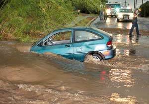 Picture of a car caught in a low water crossing due to flash flooding from a summer thunderstorm.