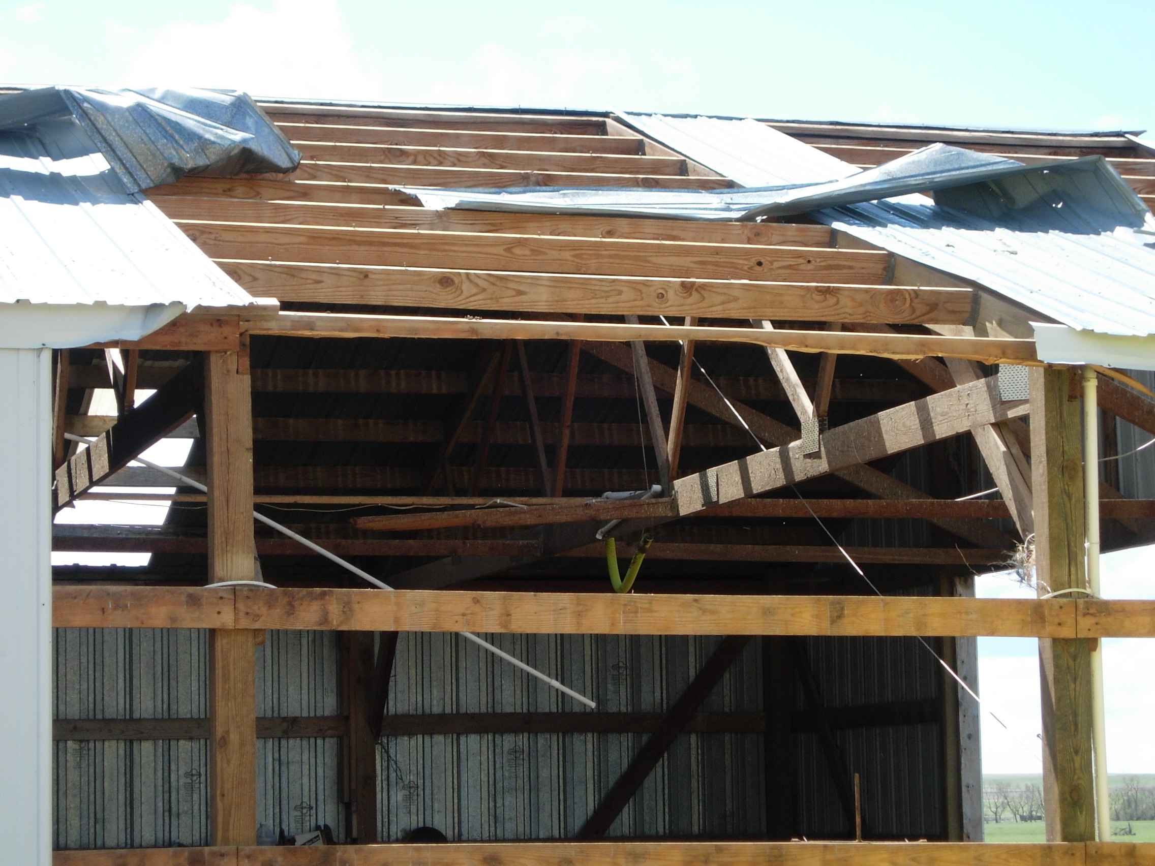Damage to a barn roof and walls northeast of Dupree