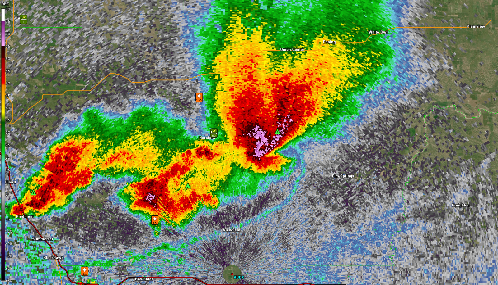 A radar image displays two intense storm cells, one near Sturgis and another forming a hook echo near Union Center.